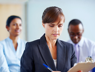 Image showing Business woman, writing and clipboard in meeting, presentation or corporate workshop at office. Female person or employee taking notes in staff training, team conference or seminar at workplace