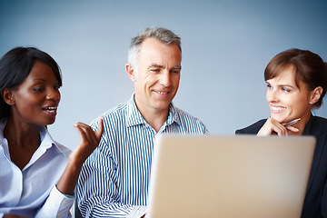 Image showing Collaboration, business people and planning with a laptop in the boardroom for vision or strategy. Smile, meeting or diversity with corporate men and women working on a computer for company teamwork