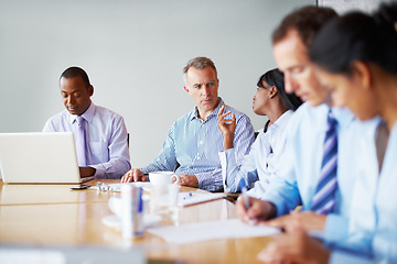 Image showing Cooperation, business people and meeting with a laptop, brainstorming and support with ideas, planning and project. Group, manager and employees with a pc, teamwork and solidarity with diversity