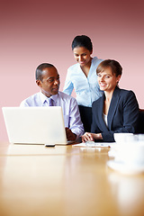 Image showing Collaboration, business people and planning on a laptop in the boardroom for strategy or discussion. Smile, teamwork or diversity with corporate men and women meeting for company vision or growth