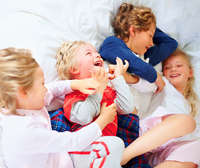 Image showing Laugh, playing and above of children in bedroom for bonding, love and cute relationship. Family, home and top view of brothers, sisters and kids for childhood games, fun and playful on bed together