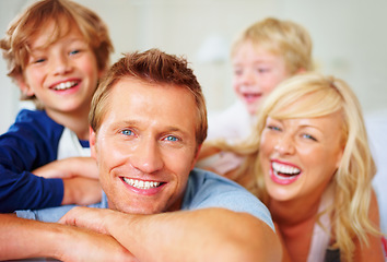 Image showing Portrait, love and laughing with a family on a bed together while in their home on a weekend morning. Face, smile or happy with dad, mom and kids in the bedroom of an apartment to relax for bonding