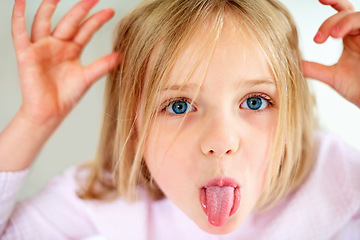 Image showing Silly, tongue out and portrait of child in home with funny, comic and humor facial expression. Childhood, crazy and closeup of young girl with hand gesture for goofy face, playful joke and emoji