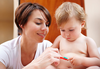 Image showing Home, family and mother with baby, toys and happiness with love, bonding together and relaxing. Infant, mama and toddler with fun, playing and house with a break, learning and child development