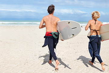 Image showing Surfer couple, running and back at beach with board, training or fitness on vacation in summer. Man, woman or surfboard for wellness, health or workout by ocean, waves or freedom on holiday in nature