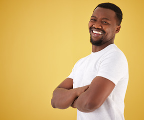 Image showing Man, portrait and smile in studio on yellow background, confidence or mockup space. Black person, model and happy face in positive mood for relax decision or deal information, yes news or show offer