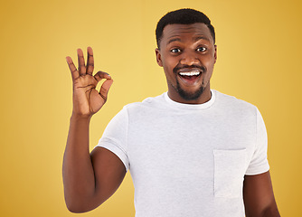 Image showing African man, ok sign and studio portrait for smile, wow and surprise for review, vote or like by yellow background. Person, hand and emoji for feedback, choice or decision with icon, symbol and happy