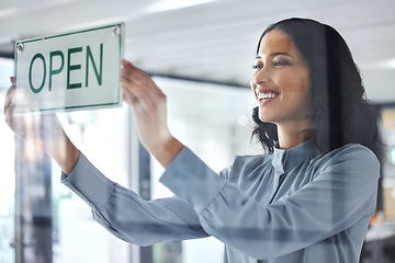 Image showing Woman, open sign and window store for business hours as professional owner, entrepreneur for customer notice. Female person, smile and holiday information for sales poster, service news for welcome