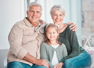 Image showing Grandparents, girl and portrait on couch, smile or hug for care, bonding or love in home living room. Old man, elderly woman and kid with happy embrace on lounge sofa, relax and pride in family house