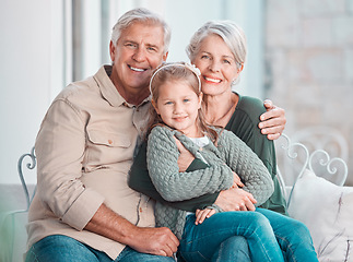 Image showing Grandparents, hug and portrait on couch with girl, care and bonding with love, retirement and home living room. Happy old man, elderly woman and embrace child in lounge, relax and pride in apartment