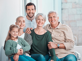 Image showing Grandparents, parents and girl on sofa, portrait and hug with care, bonding and love in family home lounge. Mom, dad and child with embrace for smile, relax and together on living room couch in house