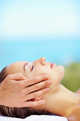 Image showing Woman, head massage and bed at spa for health, wellness of rest in recovery, peace or quiet in nature. Girl, mockup space and resort in rehabilitation, massage or blue sky background for body fatigue