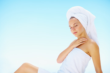 Image showing Relax, woman and spa towel outdoor with wellness, skincare and health treatment with blue sky. Mockup space, rest and zen of a calm female person on vacation with body care and ready for massage