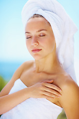 Image showing Sleep, woman and spa towel outdoor with wellness, skincare and health treatment with blue sky. Tropical vacation, rest and zen of a calm female person on vacation with body care and ready for massage