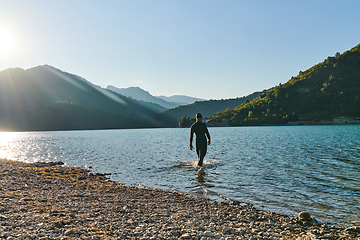 Image showing Triathlon athlete starting swimming training on lake