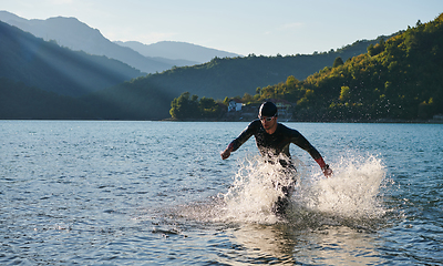 Image showing Triathlon athlete starting swimming training on lake