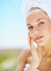 Image showing Woman, spa and outdoor with skincare, portrait or hands with face for results with blue sky background. Girl, touch skin and facial change with beauty, cosmetic transformation and wellness in nature