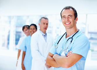 Image showing Doctors, man and arms crossed in group in clinic with staff, leader or team for healthcare services. Medic, portrait and solidarity for diversity for inclusion, women or nurses in support at hospital