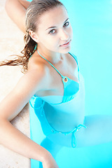 Image showing Woman, swimming pool and portrait in bikini, above and summer with health, wellness and relax on holiday. Girl, person and outdoor with swimwear by water for vacation, freedom and travel in Spain