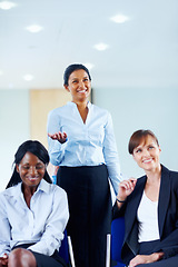 Image showing Businesswoman, smile and excited for presentation at conference, workshop or seminar in boardroom. Diverse group, happy people and listen to speaker, panel or discussion in formal, chic and fashion