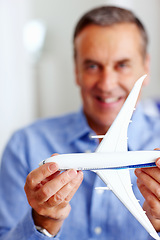 Image showing Hands, travel and model airplane with a businessman in the office for a global or international trip. Corporate, transport or journey and a happy professional employee with a toy vehicle for flight