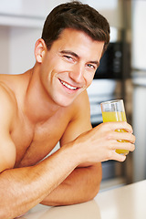 Image showing Portrait, smile and man in a kitchen, orange juice and healthy with wellness, morning and diet plan. Face, bare and person with glass, guy and home with natural drink nutrition and happiness with joy