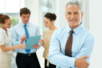 Image showing Smile, portrait and senior businessman with team of people in the office with positive, good and confident attitude. Happy, career and manager with a group of professional employees in workplace