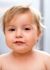 Image showing Baby, portrait and child or happy in nursery with relax, healthy and development for growth or nurture in home. Kid, infant and smile with waking up, carefree and calm expression in bedroom of house