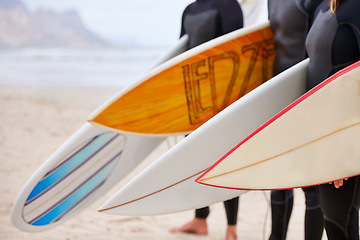 Image showing Friends, surfboard and ocean with surfing, fitness and exercise by the sea and beach. Group, outdoor and surfer with travel, training and water on vacation and holiday in Miami with freedom on trip