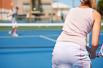 Image showing Tennis, sport or woman with rear view on court for competition, match or training outdoor with racket. Player, person or game with exercise, workout or competitive with partner for fitness in summer
