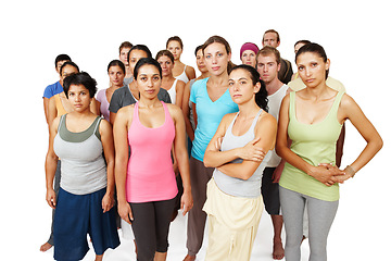 Image showing Portrait, group of people in studio for yoga and fitness with serious face, commitment and wellness. Pilates team, men and women in class together, community of holistic health on white background.