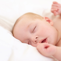 Image showing Baby, sleeping and bed in home, closeup and nursery with growth, development and wellness in room. Infant, child and newborn with rest, tired or dream in bedroom for health in family house with peace