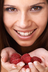 Image showing Face, woman and healthy raspberry fruits in hands for detox, vegan diet and eco nutrition. Portrait, happy girl and holding red berries for organic food, sustainable wellness or benefits of vitamin c