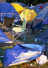 Image showing Tents, trash and litter at an outdoor music festival or event for a celebration party or social gathering. Summer, campsite and trash with untidy camping gear, chairs or cooler boxes on the ground