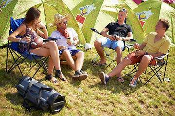Image showing Camping, group of friends in conversation at tent and relax with outdoor chat, drinks and grass. Nature, men and woman at campsite together for music festival, adventure and people bonding in park.