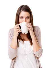 Image showing Casual woman, portrait and drinking coffee in mug or cup against a white studio background. Calm, young and attractive female person with warm beverage, sip or morning in fresh start or stress relief