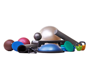Image showing Studio, gym equipment and fitness in mockup for sport, training and exercise for health lifestyle. Hand weights, accessories and ball with dumbbell or yoga mat and gym gadgets by white background