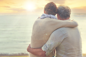 Image showing Old couple, hug and sunset on sea at the beach with care, support and trust in marriage or retirement. Back, man and woman in embrace with love, kindness and gratitude for vacation or holiday