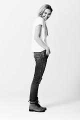 Image showing Portrait, smile and fashion with a monochrome woman in studio on a white background for casual style. Model, happy or natural with a confident young person in black and white to wear trendy clothes