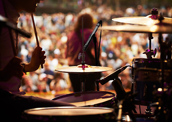 Image showing Drums, playing and closeup of hands, concert and music festival in outdoors, talent and audience. Band, performance and entertainment for crowd, instrument and rhythm for people, sound and rock