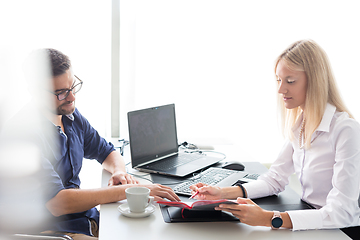 Image showing Business meeting. Client consulting. Confident business woman, real estate agent, financial advisor explaining details of project or financial product to client in office.