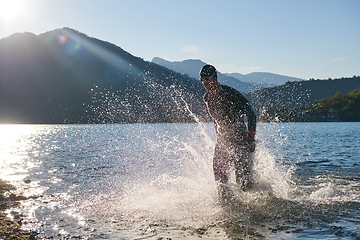 Image showing Triathlon athlete starting swimming training on lake