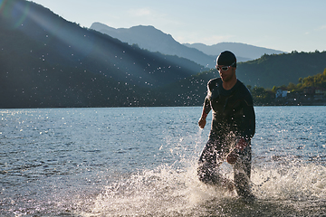 Image showing Triathlon athlete starting swimming training on lake