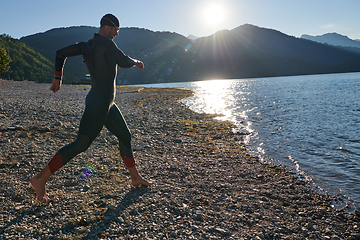 Image showing Triathlon athlete starting swimming training on lake