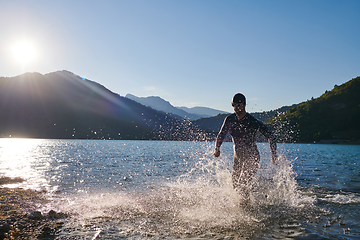 Image showing Triathlon athlete starting swimming training on lake