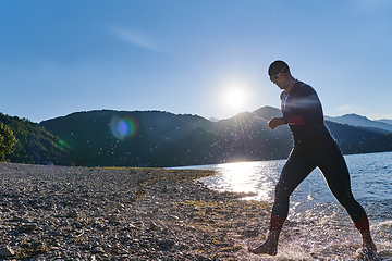 Image showing Triathlon athlete starting swimming training on lake