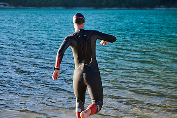 Image showing Triathlon athlete starting swimming training on lake