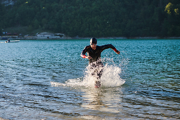 Image showing Triathlon athlete starting swimming training on lake