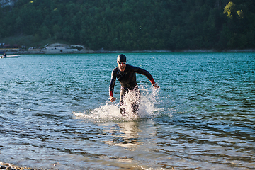 Image showing Triathlon athlete starting swimming training on lake