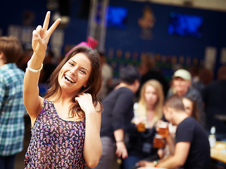 Image showing Woman, outdoors and smile in portrait, peace sign and fun on vacation or traveling. Happy female person, face and holiday in Ibiza, casual and cool fashion for party, concert and emoji for freedom